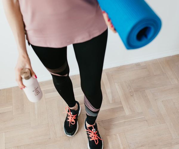 Comfortable sneakers and a water bottle ready for exercise.